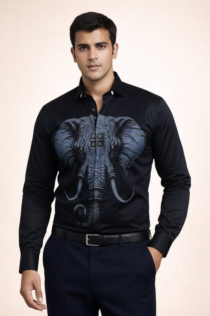 Man wearing a black shirt with an elephant design on a beige background