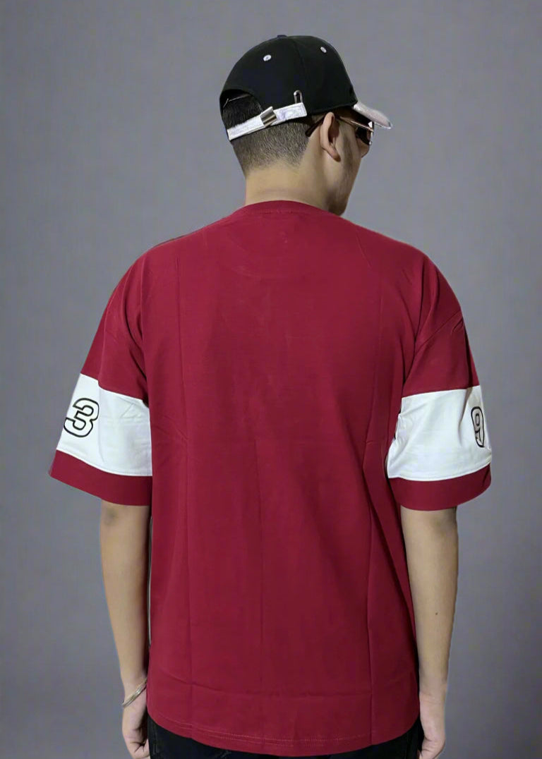 Person wearing a red sports jersey with white accents on a gray background