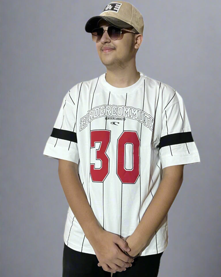Person wearing a white baseball jersey with red number 30 and black stripes, standing against a light blue background.