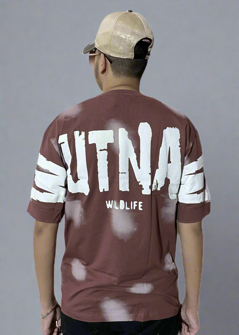 Person wearing a maroon sports jersey with 'UTNA' branding on the back, standing against a light blue background.