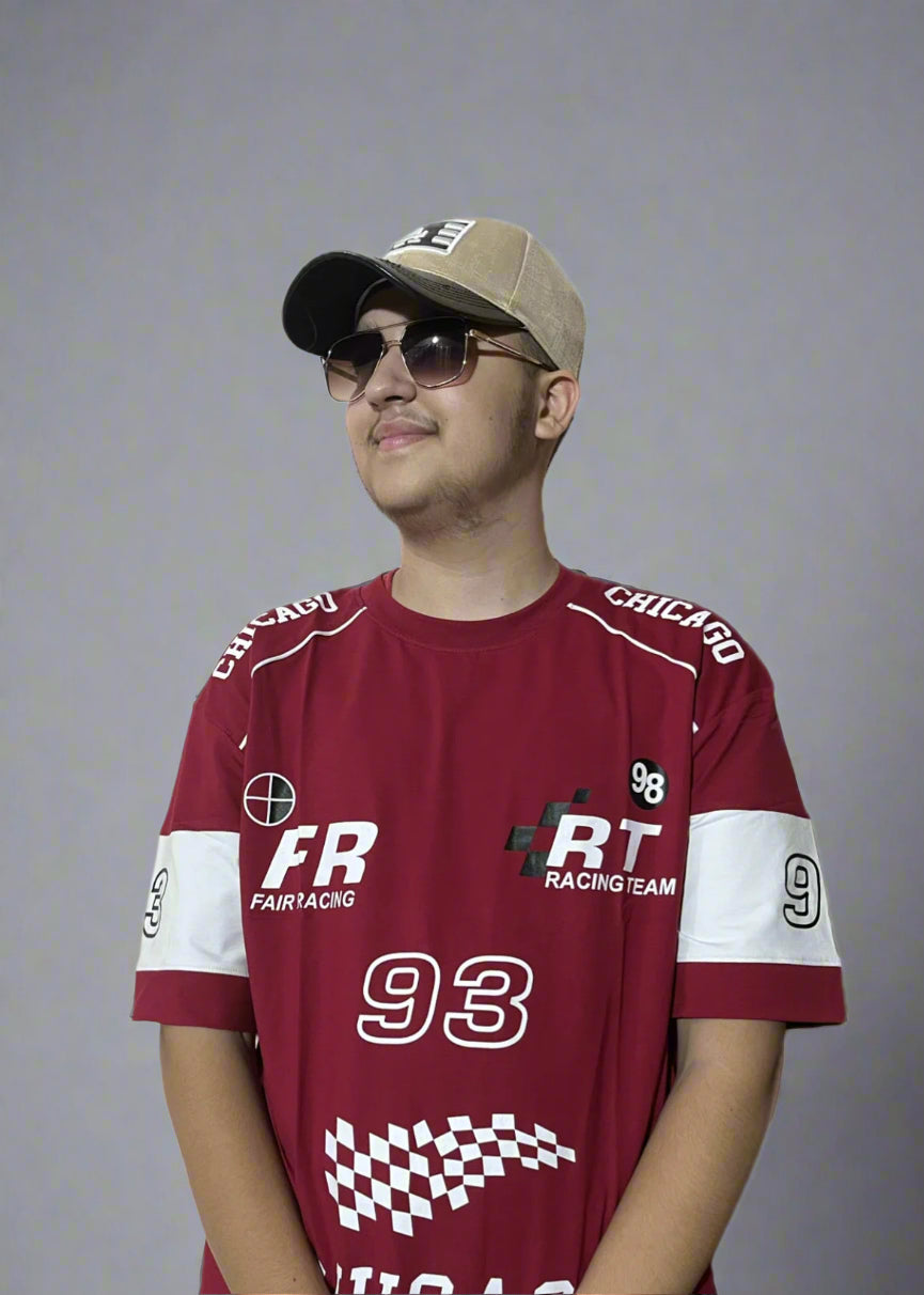 Person wearing a maroon racing-themed shirt with visible branding on a light gray background