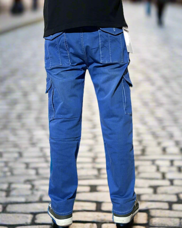 Blue cargo pants worn over a black shirt on a white background