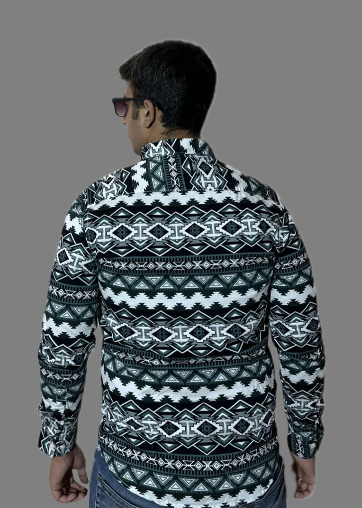 Man wearing a patterned shirt on a white background