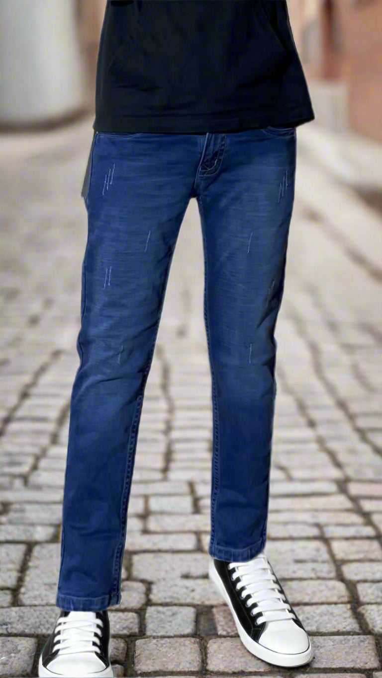 Person wearing blue jeans and black sneakers on a white background